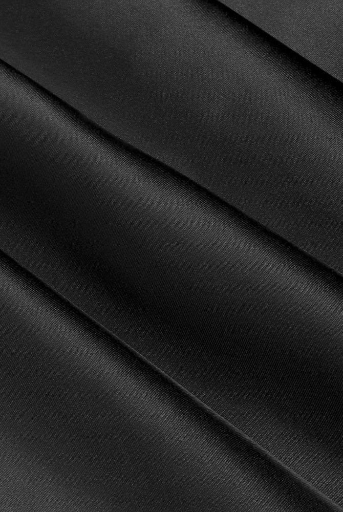 Black satin fabric with smooth sheen and diagonal fold lines