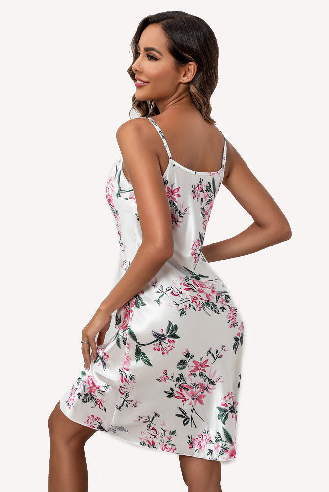 White floral satin slip dress with spaghetti straps, V-back, draped skirt