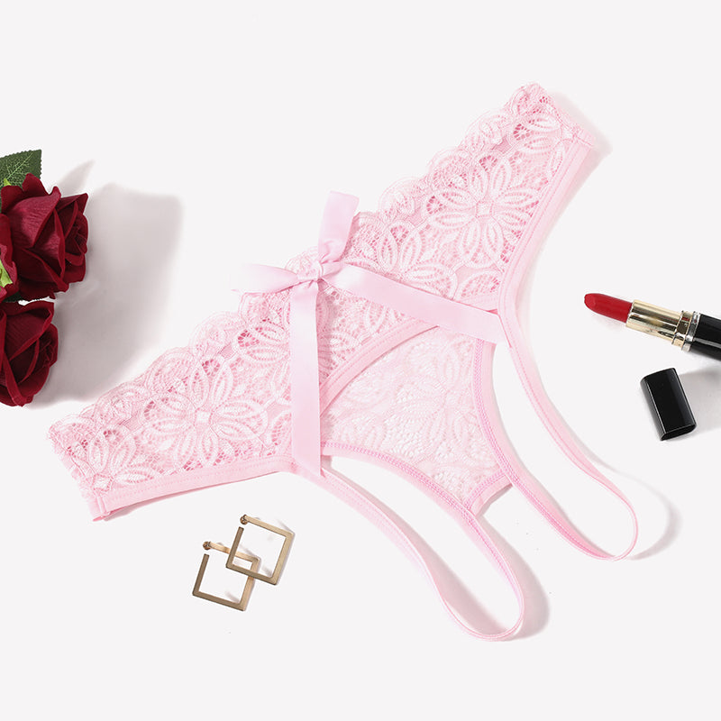 Pink lace briefs with openwork rear and back bow, scalloped edges, ribbon ties.