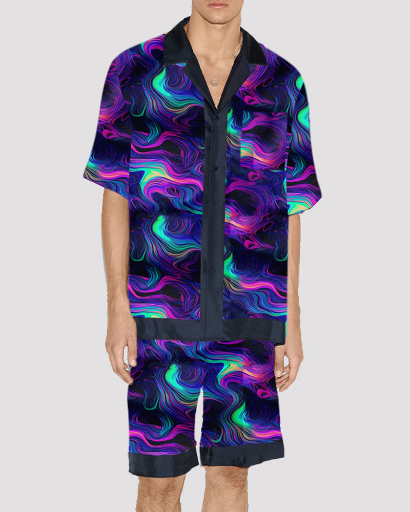 Men's satin pajama set with neon swirl pattern, short-sleeve button-up and shorts