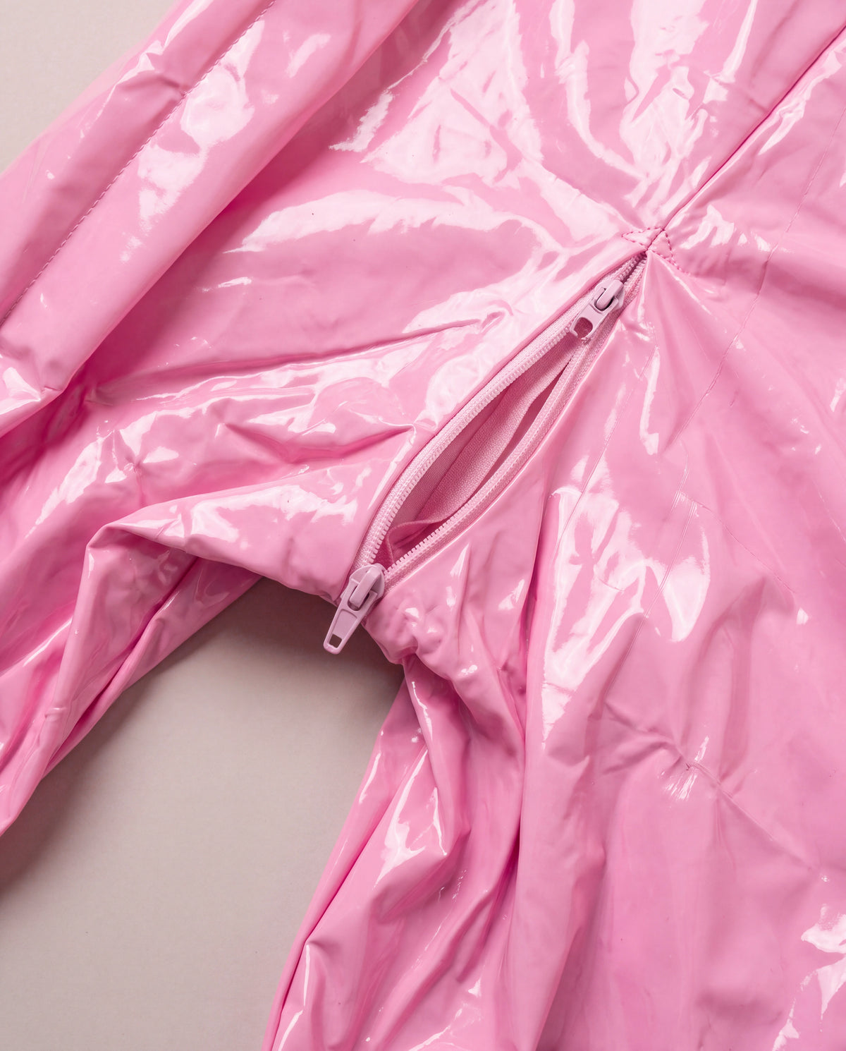 Light pink PU leather catsuit with double zippers and open crotch detail