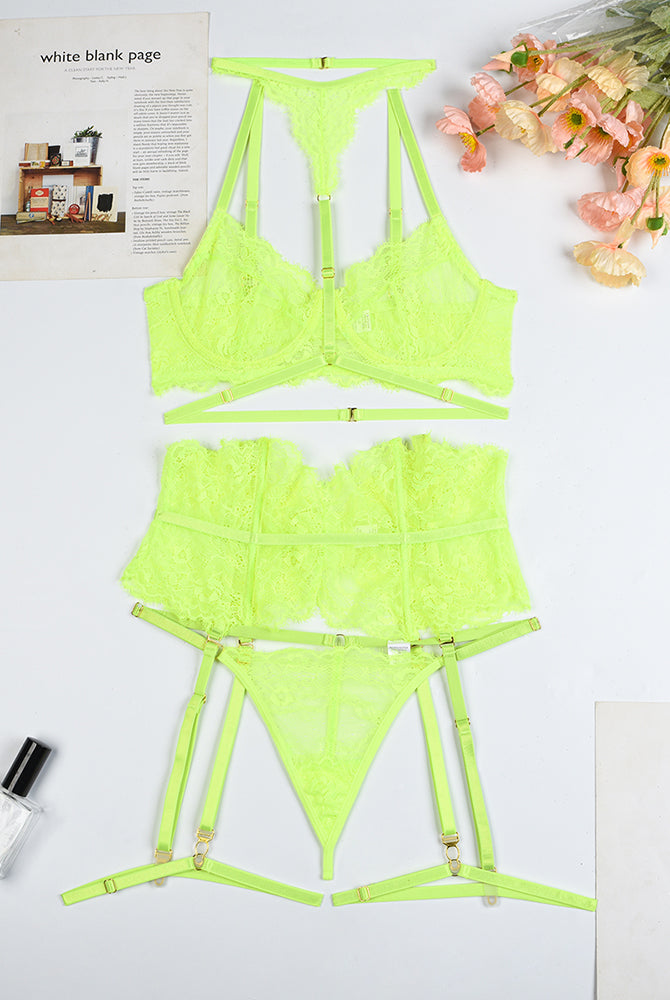 Neon green lace bra, panty, and garter belt set laid flat with matching hardware
