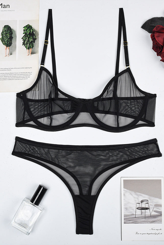 Black sheer mesh underwire bra and thong panty set, flat lay