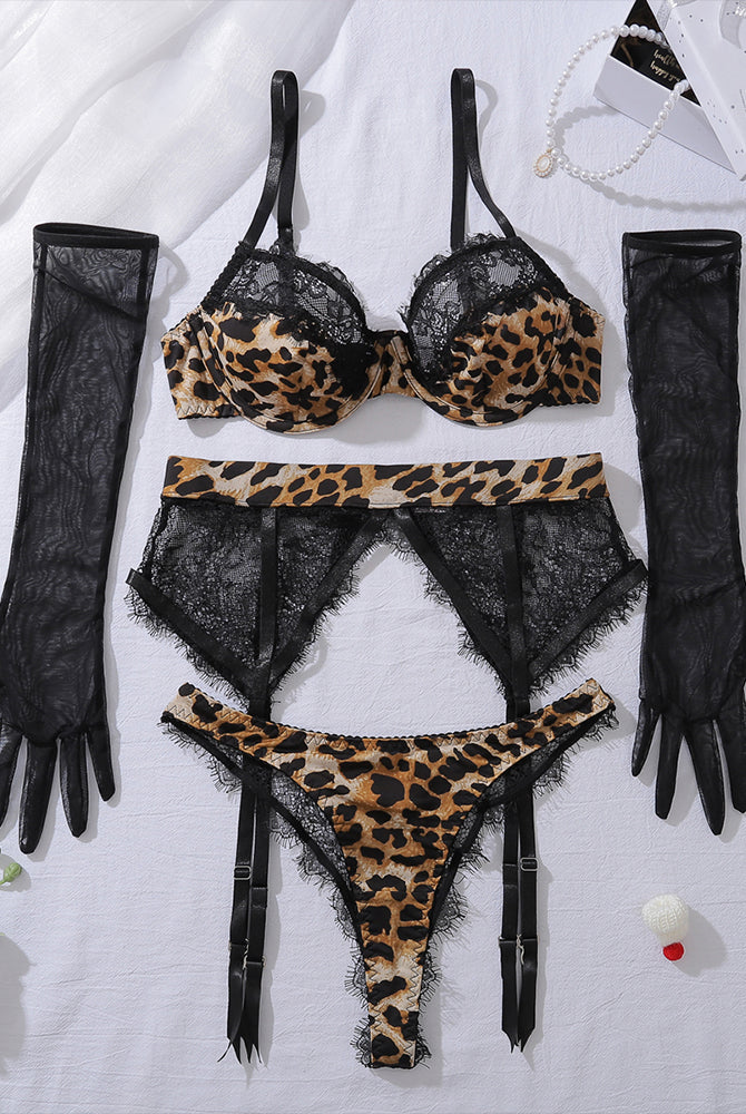 Flat lay black and leopard lace lingerie set: underwire bra, thong, garter belt, gloves