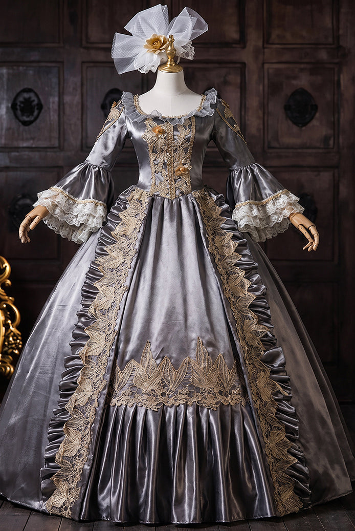 Charcoal gray medieval court gown on mannequin with gold embroidery and lace-trim bell sleeves
