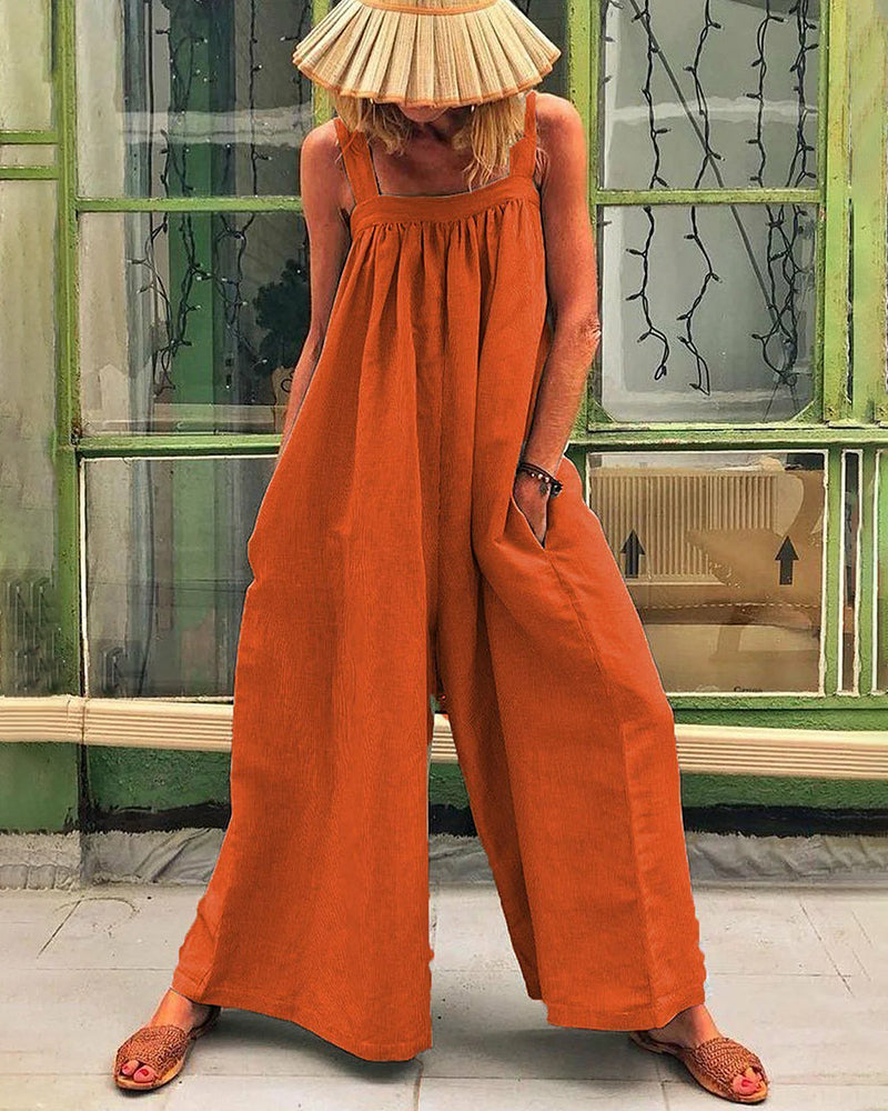 Orange sleeveless backless bodysuit with wide-leg trousers, gathered neckline