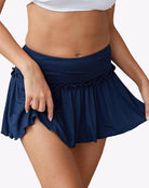 Navy ruffle mini skirt with elastic waistband and gathered, flared bottom