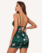Green floral satin pajama set, back view: lace camisole straps and lace ruffle shorts