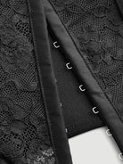 Black lace crop top close-up with front zipper tabs