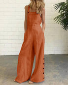 Orange wide-leg bib romper with adjustable straps and side button placket
