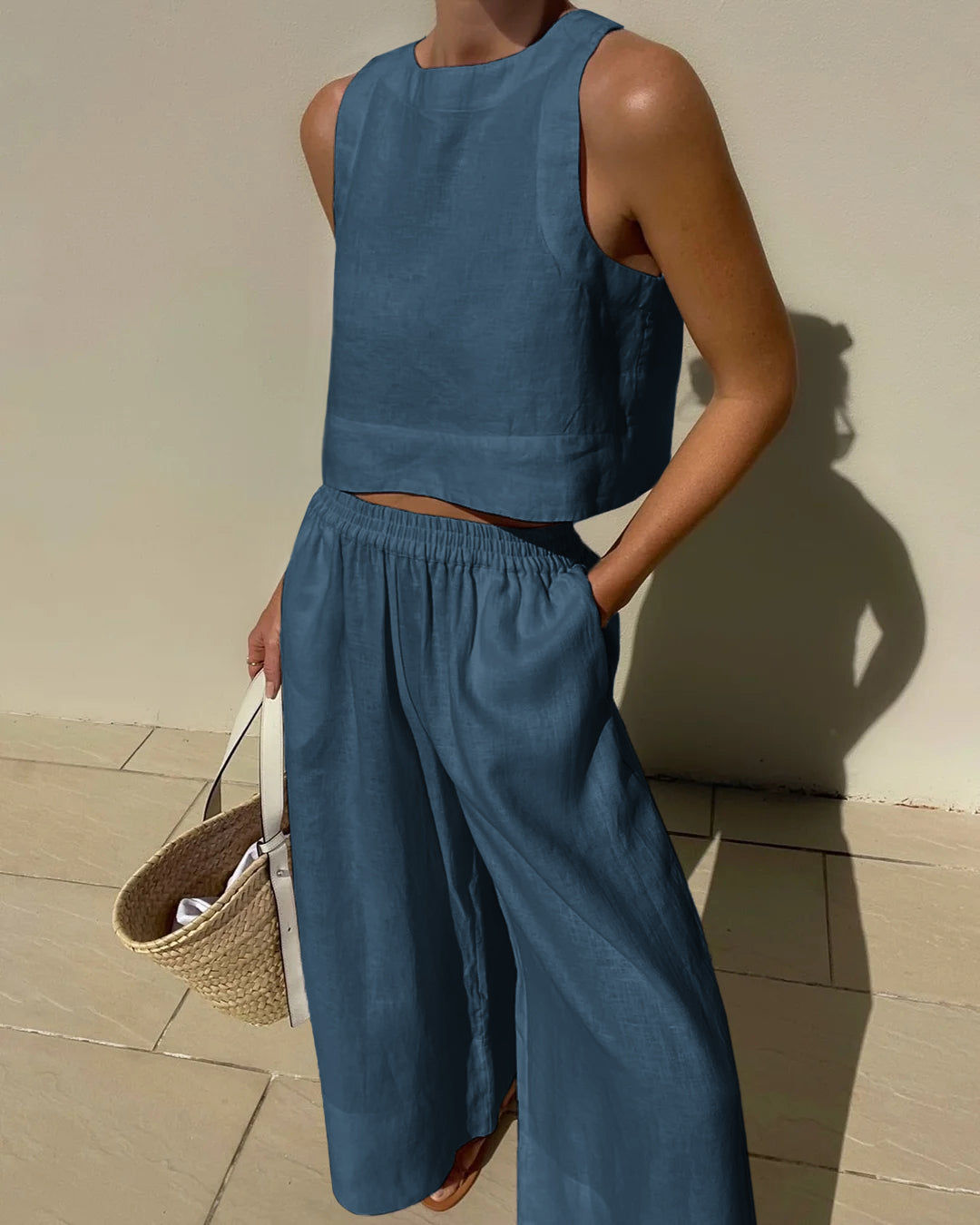 Blue sleeveless crop top and wide-leg pants set with elastic waist, relaxed wide legs.
