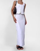 White sleeveless vest and long pencil skirt set with button-front design