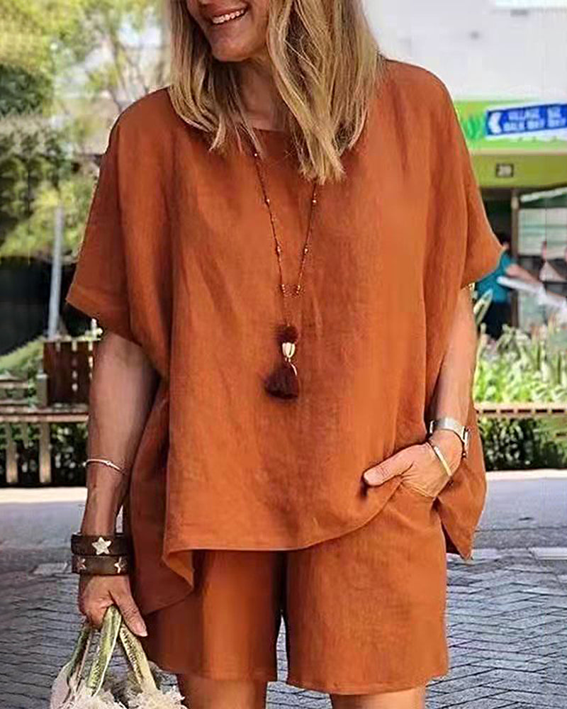 Orange two-piece shorts set with loose short-sleeve top and matching elastic-waist shorts