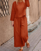 Orange long-sleeve two-piece set: layered top and wide-leg pants