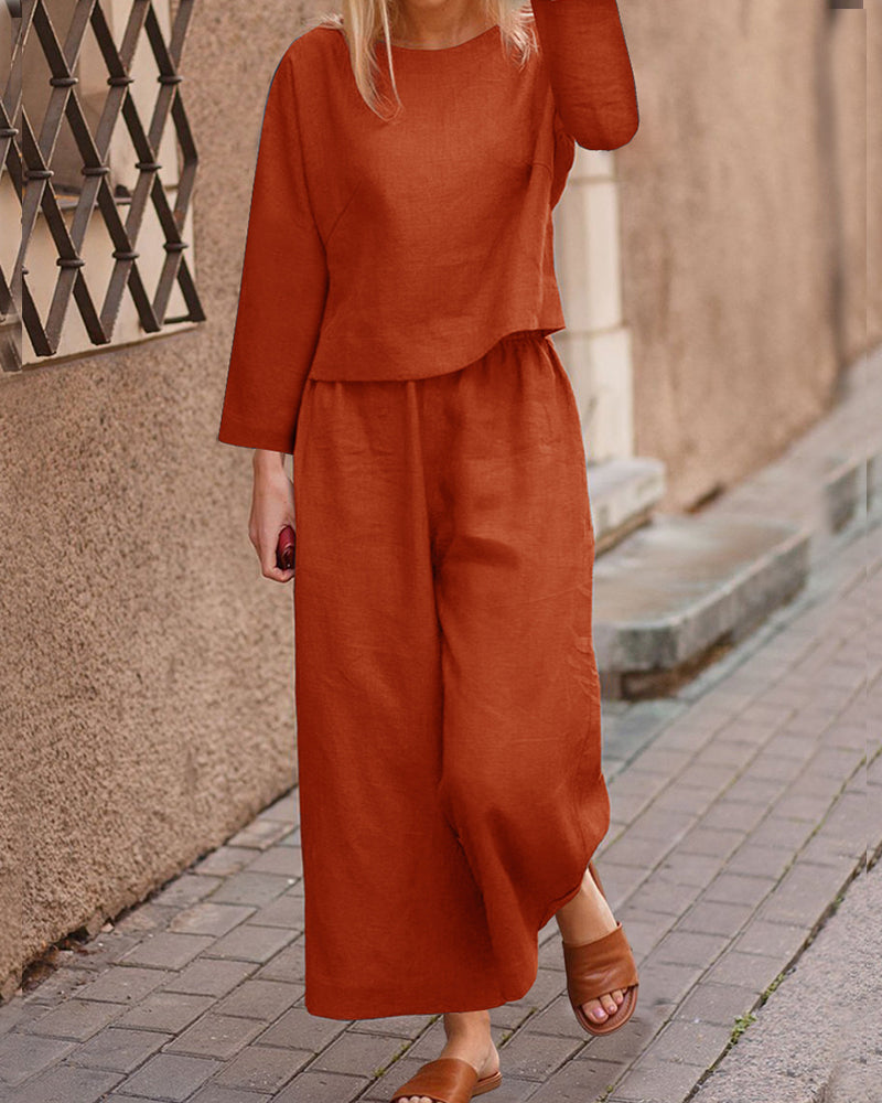 Orange long-sleeve two-piece set: layered top and wide-leg pants