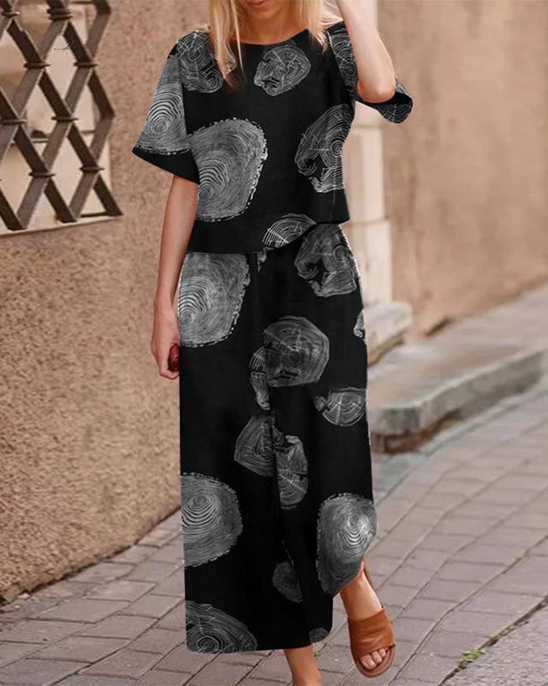 Black two-piece set with short-sleeve top and matching wide-leg pants, gray circular print