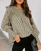 Khaki chiffon blouse with small black polka dots, ruffled neckline and long sleeves
