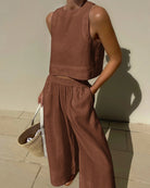 Brown sleeveless crop top and wide-leg pants set with elastic waist, relaxed wide legs.
