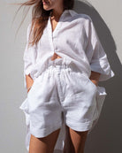 White button-up shirt and matching shorts set, V-neck collar, rolled sleeves