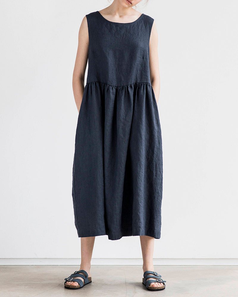 Navy blue sleeveless maxi dress with round neck and gathered waist, loose fit