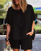 Black two-piece shorts set with loose short-sleeve top and matching knee-length shorts