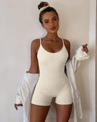 Beige ribbed tummy control romper with spaghetti straps and built-in shorts legs