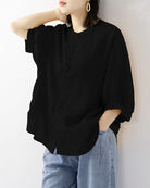 Black lantern-sleeve loose shirt with round neck and front button closure