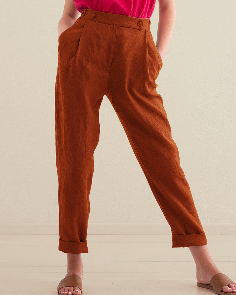 Caramel high-waist trousers with pockets, button front, and rolled cuffs