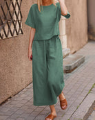 Green two-piece set with loose T-shirt and wide-leg cropped pants