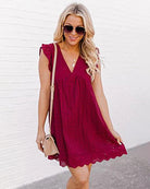 Burgundy lace sleeveless dress with V-neck and side pockets, scalloped hem.