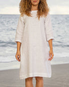 White loose-fit mini dress with round neckline and 3/4 sleeves