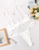 White lace underwire bra and matching thong set, scalloped lace edges