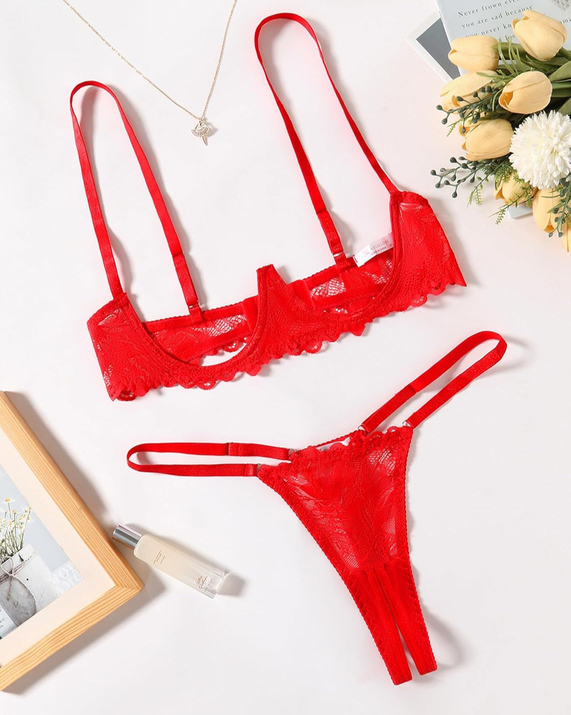 Red lace underwire bra and thong panty set, flat lay