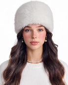 White faux fur cossack hat with plush rounded crown and ear-covering brim
