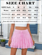 Pink pleated mini skirt with tiered ruffle layers and elastic waistband