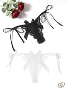 Lace thong with bows in black and white, tie side straps
