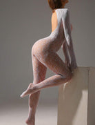 White fishnet bodysuit with long sleeves and open-back silhouette