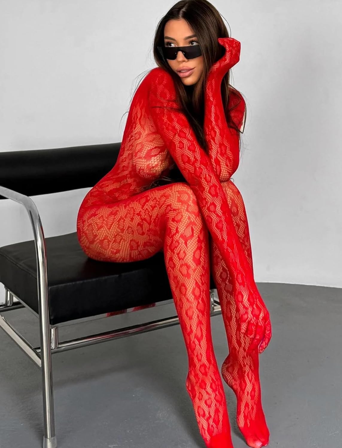Red fishnet bodysuit with long sleeves, formfitting bodice, and leg openings