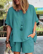 Teal two-piece shorts set with loose short-sleeve blouse-style top and matching shorts