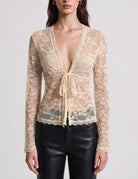 Champagne sheer lace V-neck tie-front cardigan with long sleeves, scalloped edges