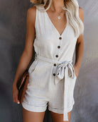 Apricot linen-look sleeveless jumpsuit romper with V-neck, button front, tied bow waist
