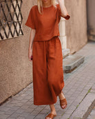 Rust two-piece set with loose T-shirt and wide-leg cropped pants