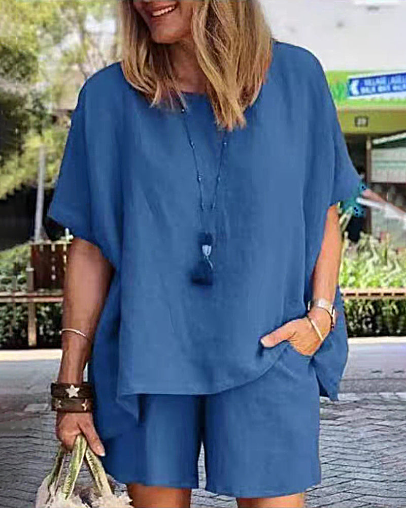 Blue two-piece shorts set with loose short-sleeve top and matching knee-length shorts