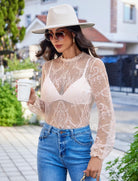 Sheer long-sleeve lace mesh top with floral pattern, fitted yoke and lace cuffs