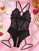 Black lace crotchless bodysuit with garter belt, lace triangle panels and garter straps