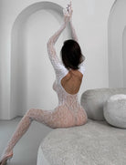 White fishnet bodysuit with long sleeves, open back, and full-length coverage