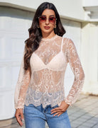 Sheer long-sleeve lace mesh top with floral pattern, V-shaped yoke and scalloped hem