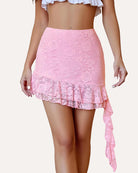 Pink lace mini skirt with asymmetrical ruffle hem and long side drape