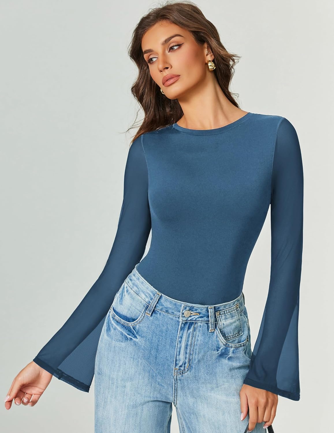 Long-sleeve bodysuit in medium blue with flared sleeves and high-cut legs