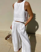 White sleeveless crop top and wide-leg pants set with elastic waist, relaxed fit.